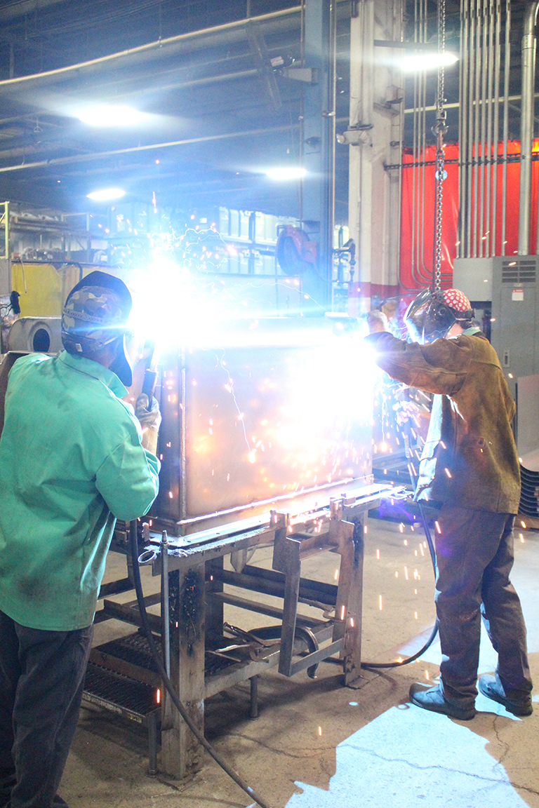 Armor Contract Manufacturing Workers Welding in Shop